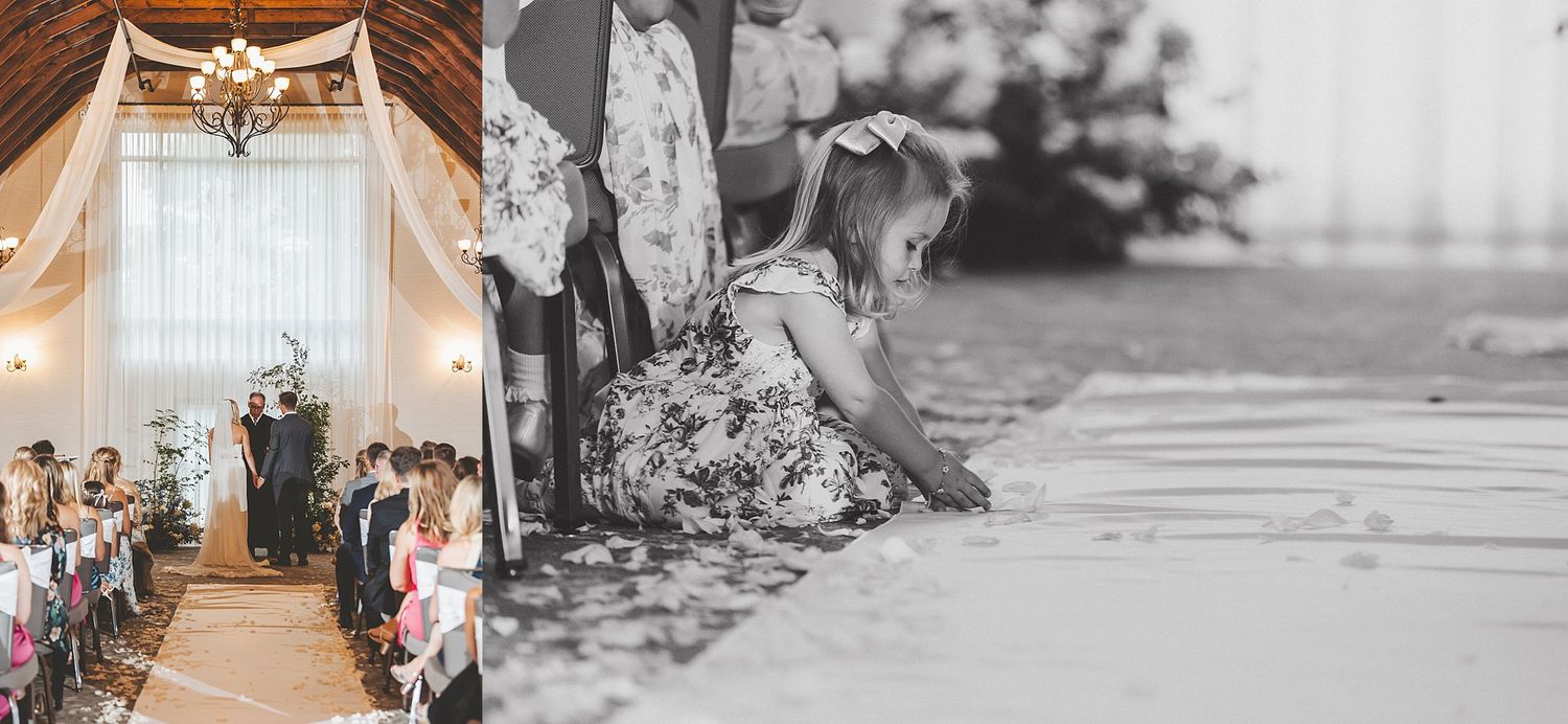 Wedding ceremony in a rustic indoor venue with draped white fabric and floral decorations.