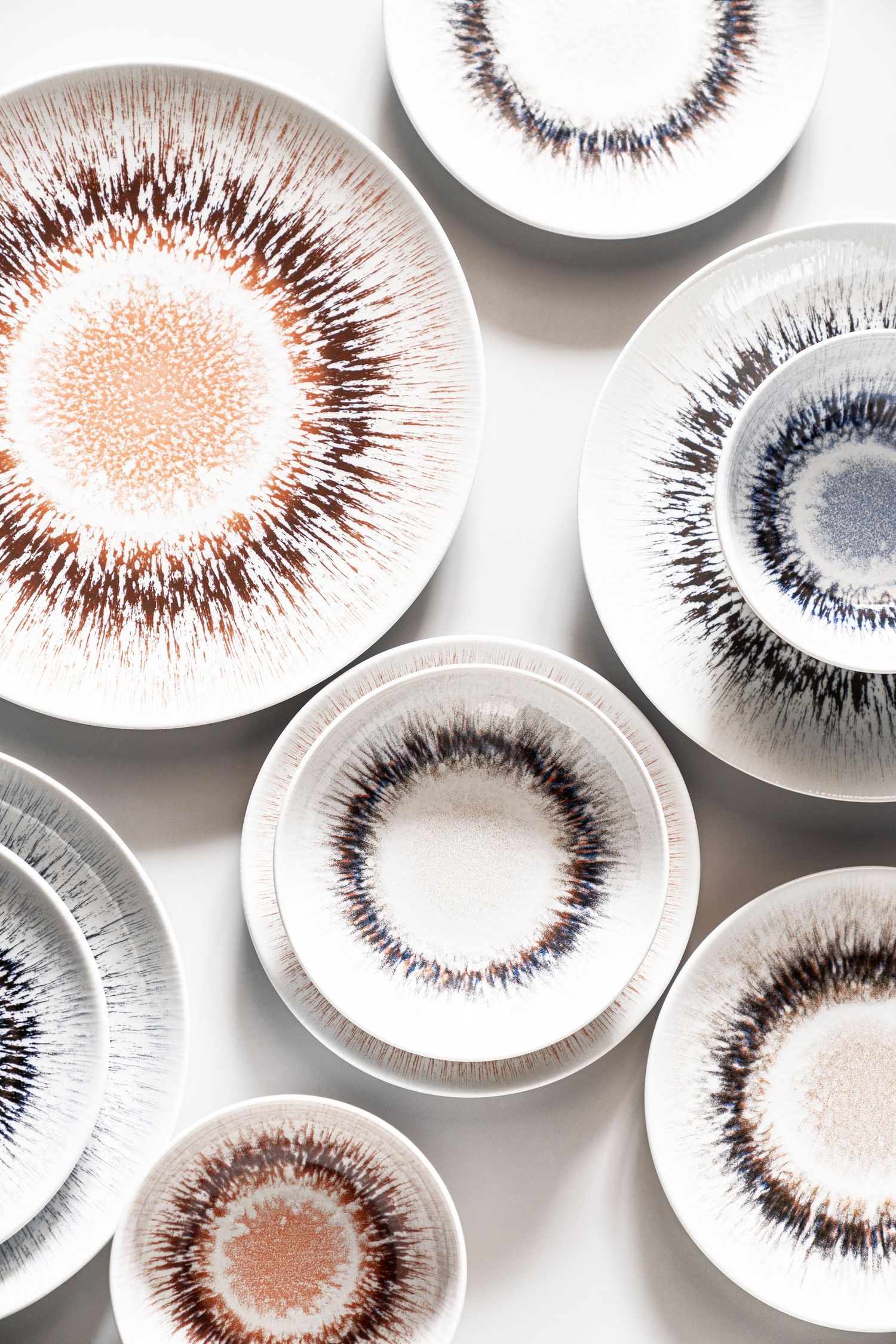 Porcelain collection Spheres with digital print in various earthy tones and radial patterns.