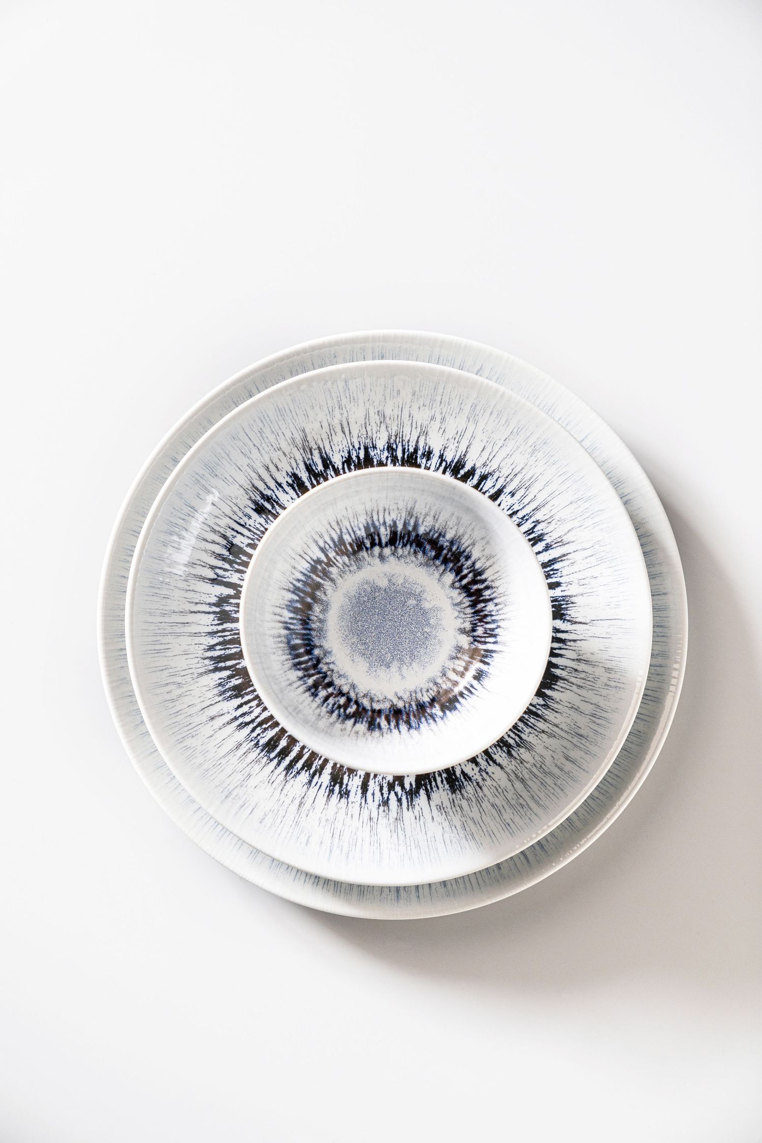 Porcelain collection Spheres with digital print in various earthy tones and radial patterns.