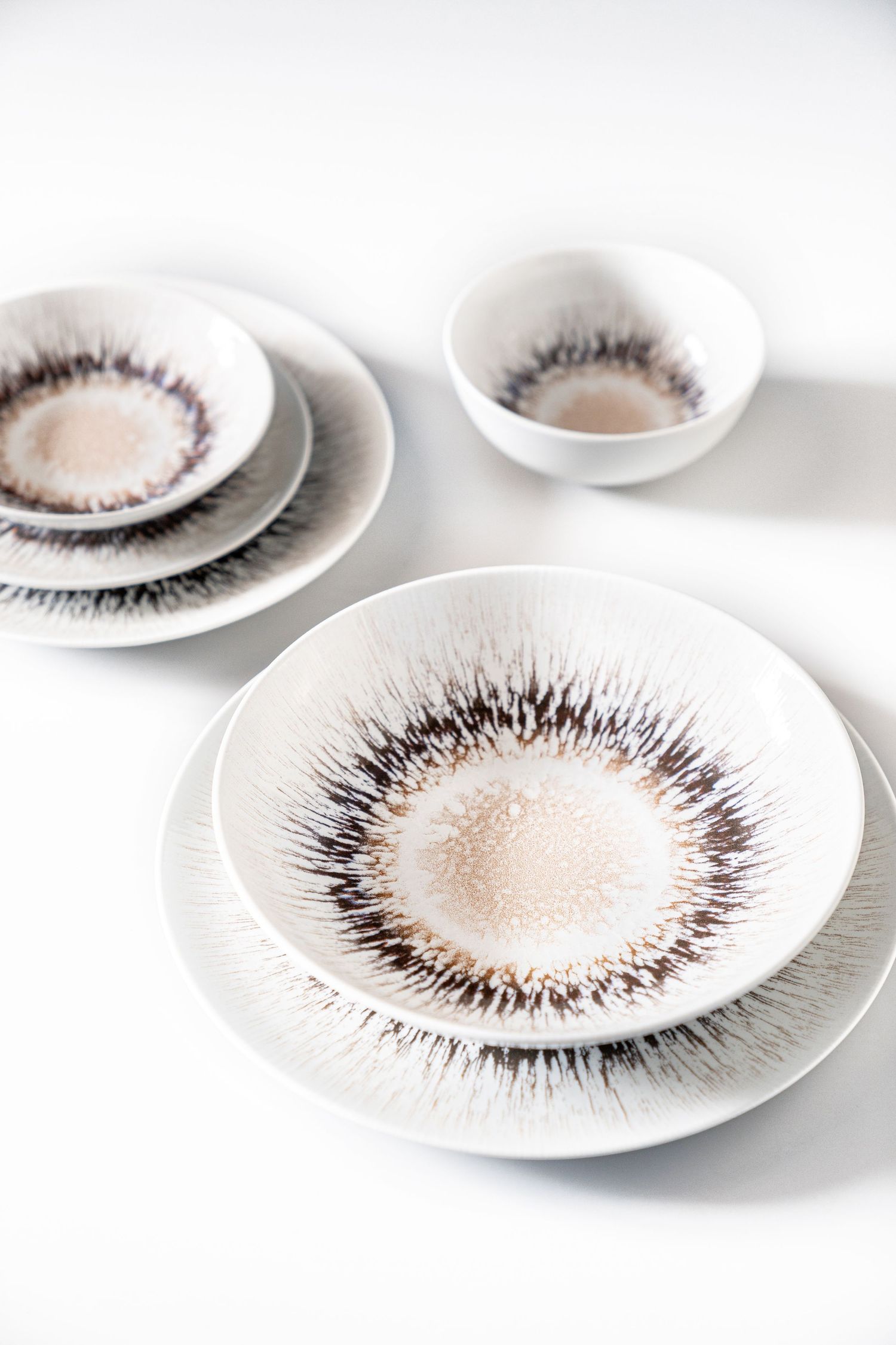 Porcelain collection Spheres with digital print in various earthy tones and radial patterns.