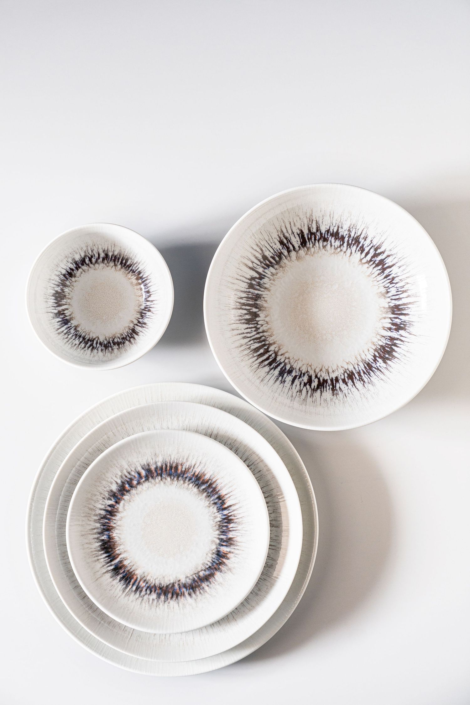Porcelain collection Spheres with digital print in various earthy tones and radial patterns.