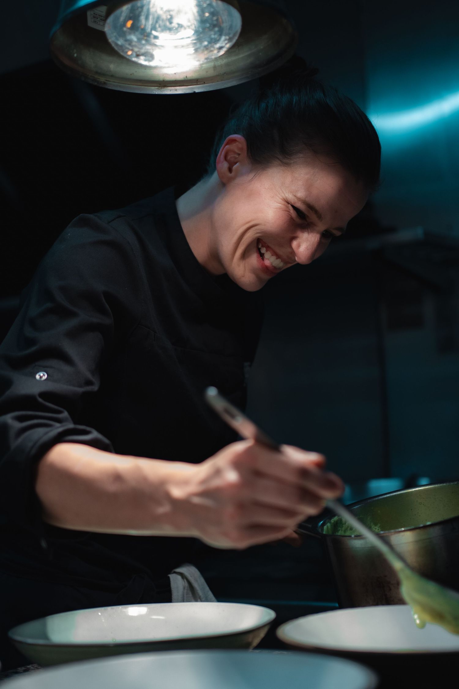 Chef plating a dish in a Bordeaux restaurant, captured by a photographer specializing in culinary and restaurant photogr