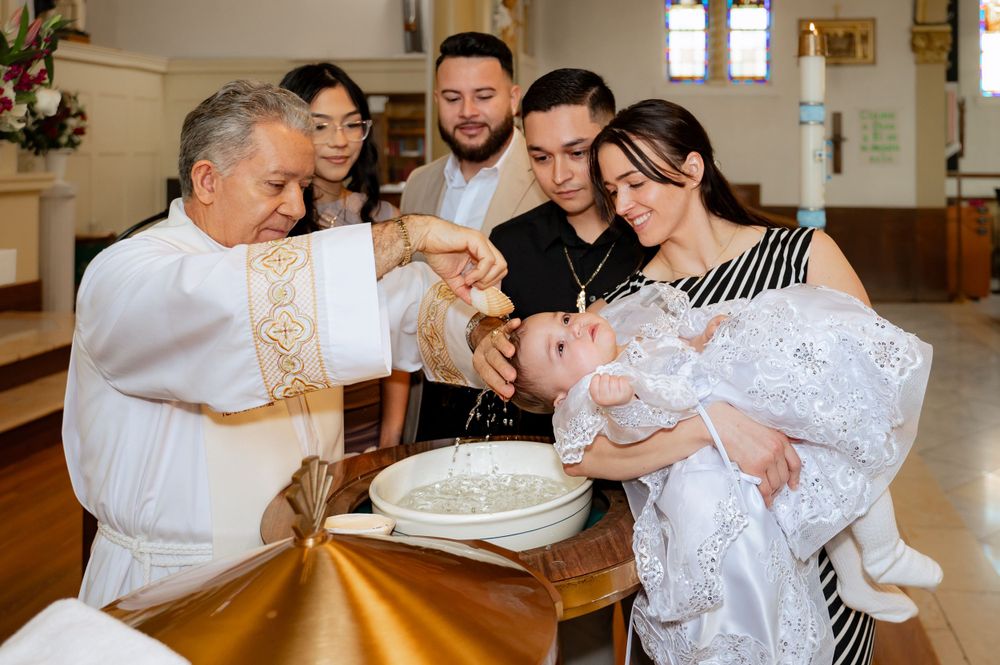 A baptism celebration with family members gathered in a church.