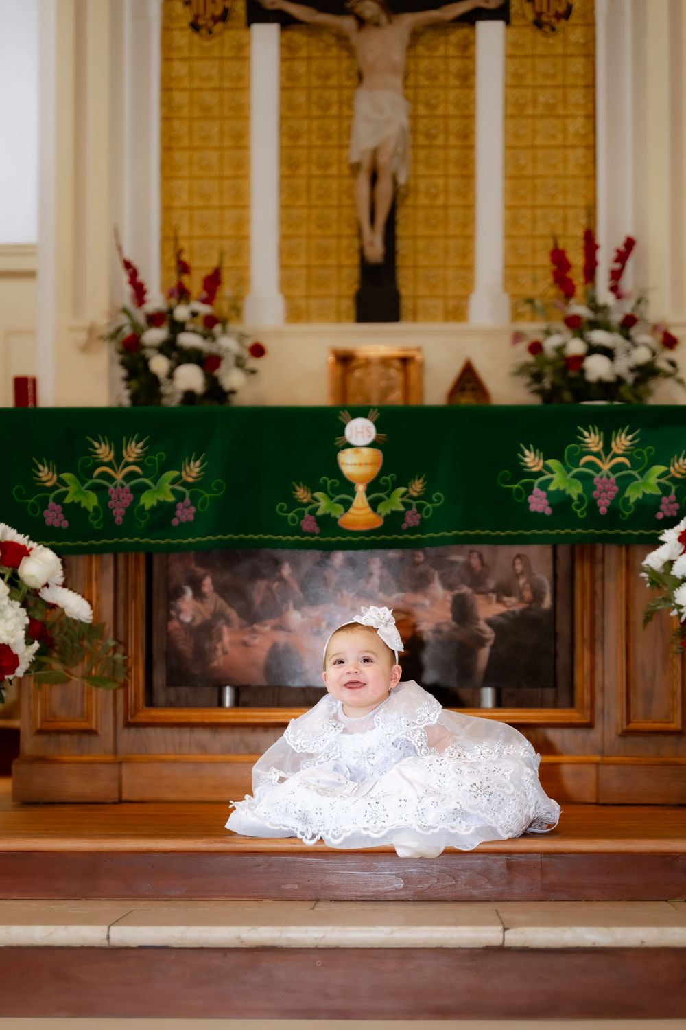 A christening ceremony captured in a beautifully decorated church altar area.