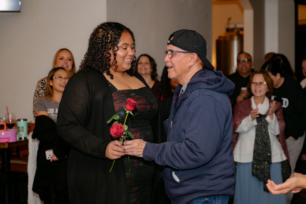 People dancing and socializing at an indoor party or celebration.