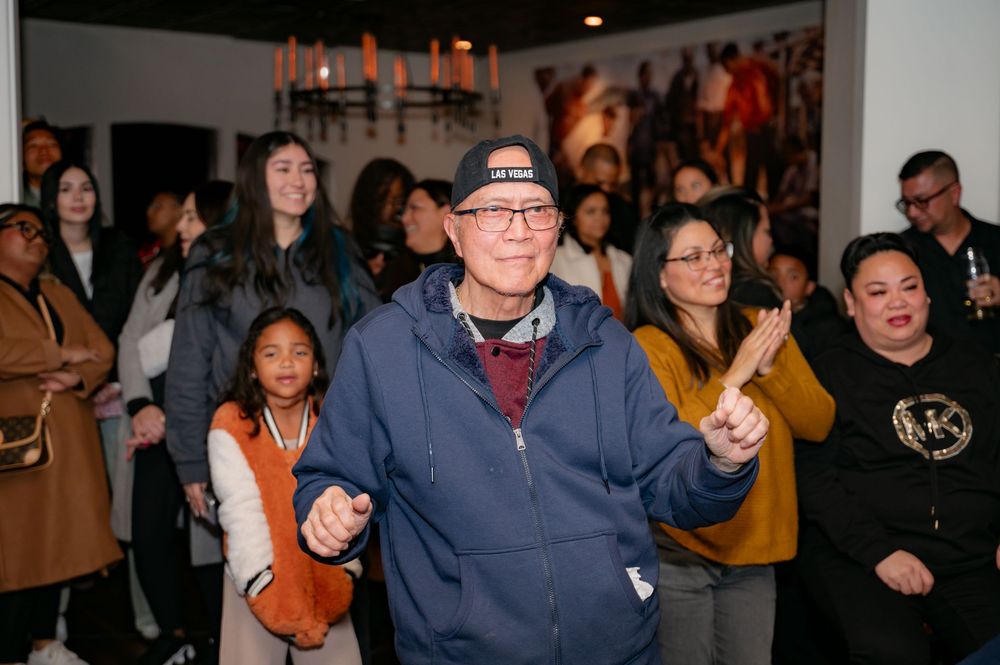 Crowd of people enjoying themselves at an indoor social gathering.