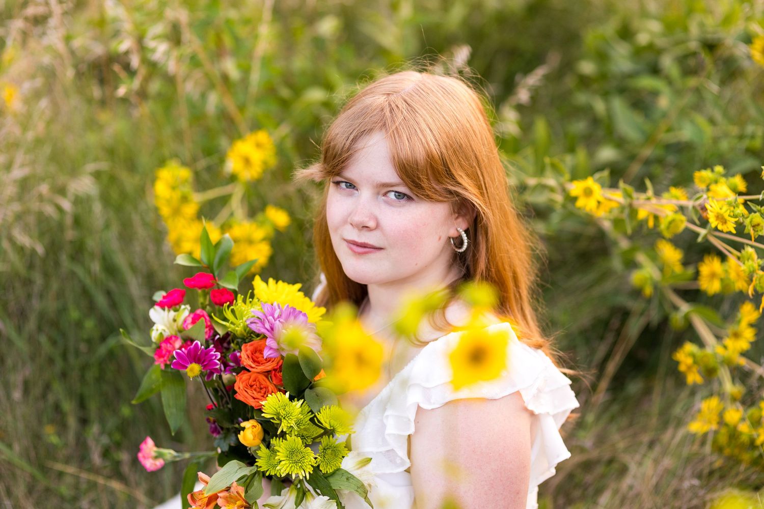 Female High School Senior in a field with flowers