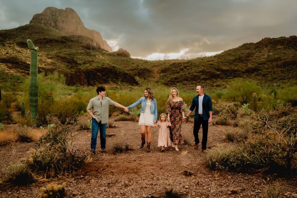 Family walking through desert foothills near Vail AZ at golden hour, natural light family photographer.