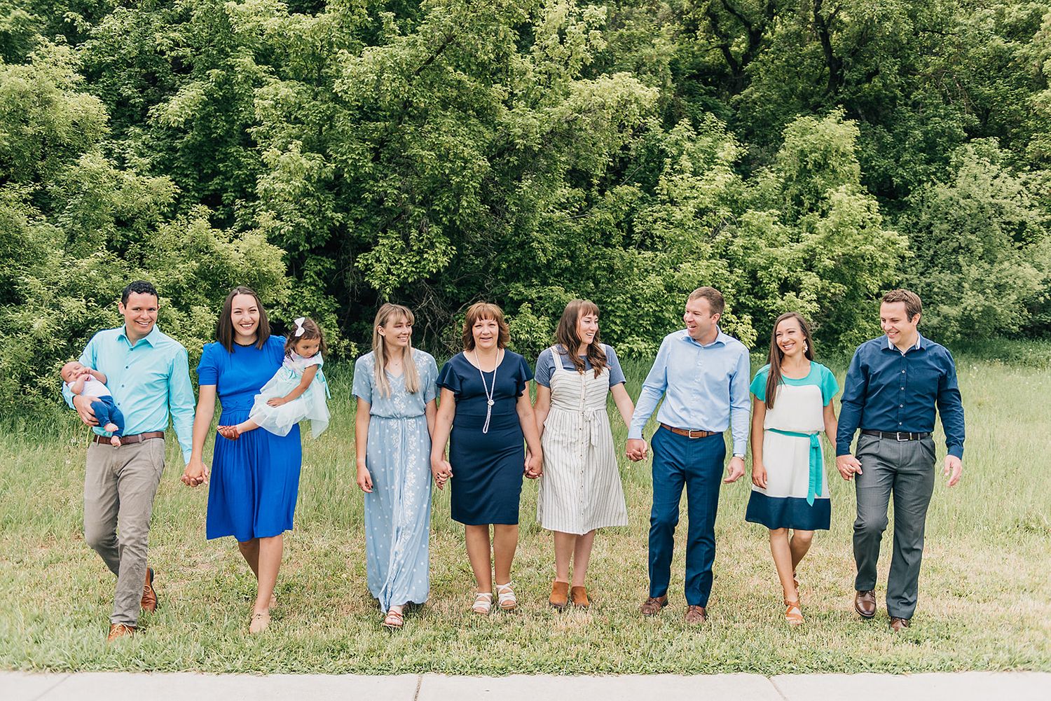 Group photo of people lined up outdoors wearing coordinated blue and white outfits.