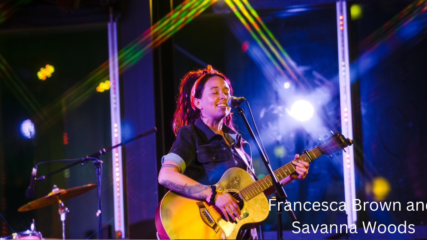 A country music performance on stage with dramatic lighting and guitar.