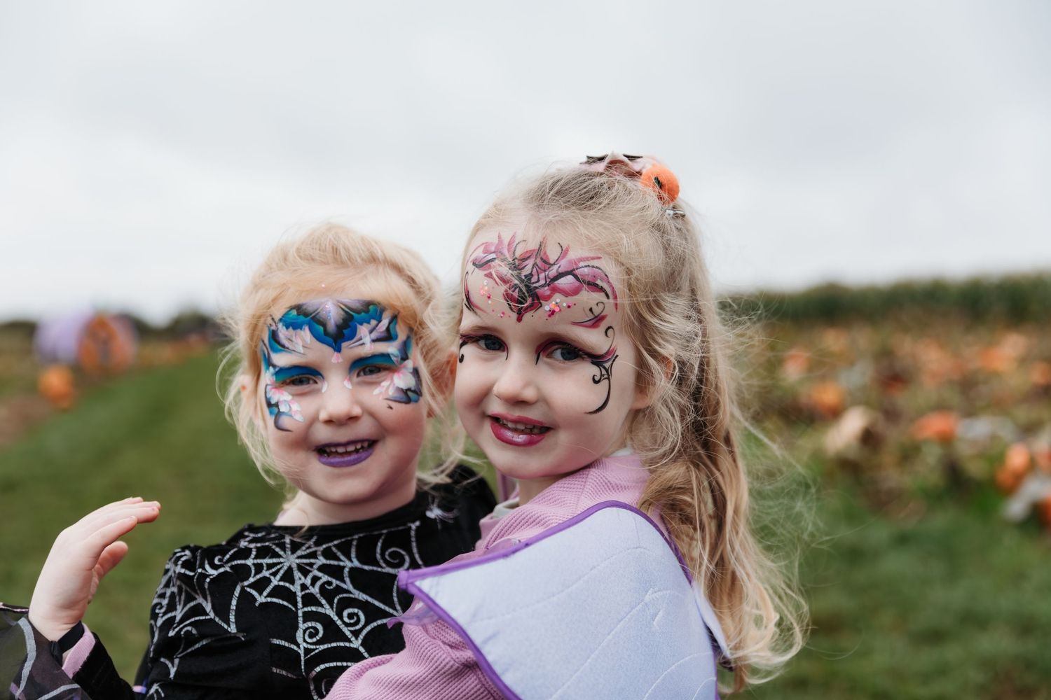 Two children with festive face paint smiling at a pumpkin patch event. Photographer. Hull. East Yorkshire. Photography
