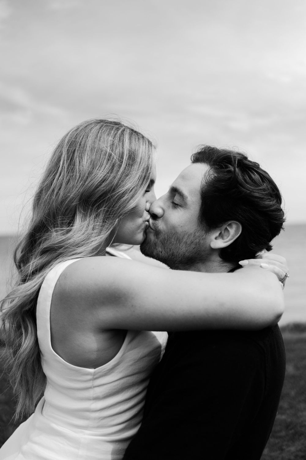 Black and white portrait captures tender romantic moment between couple.