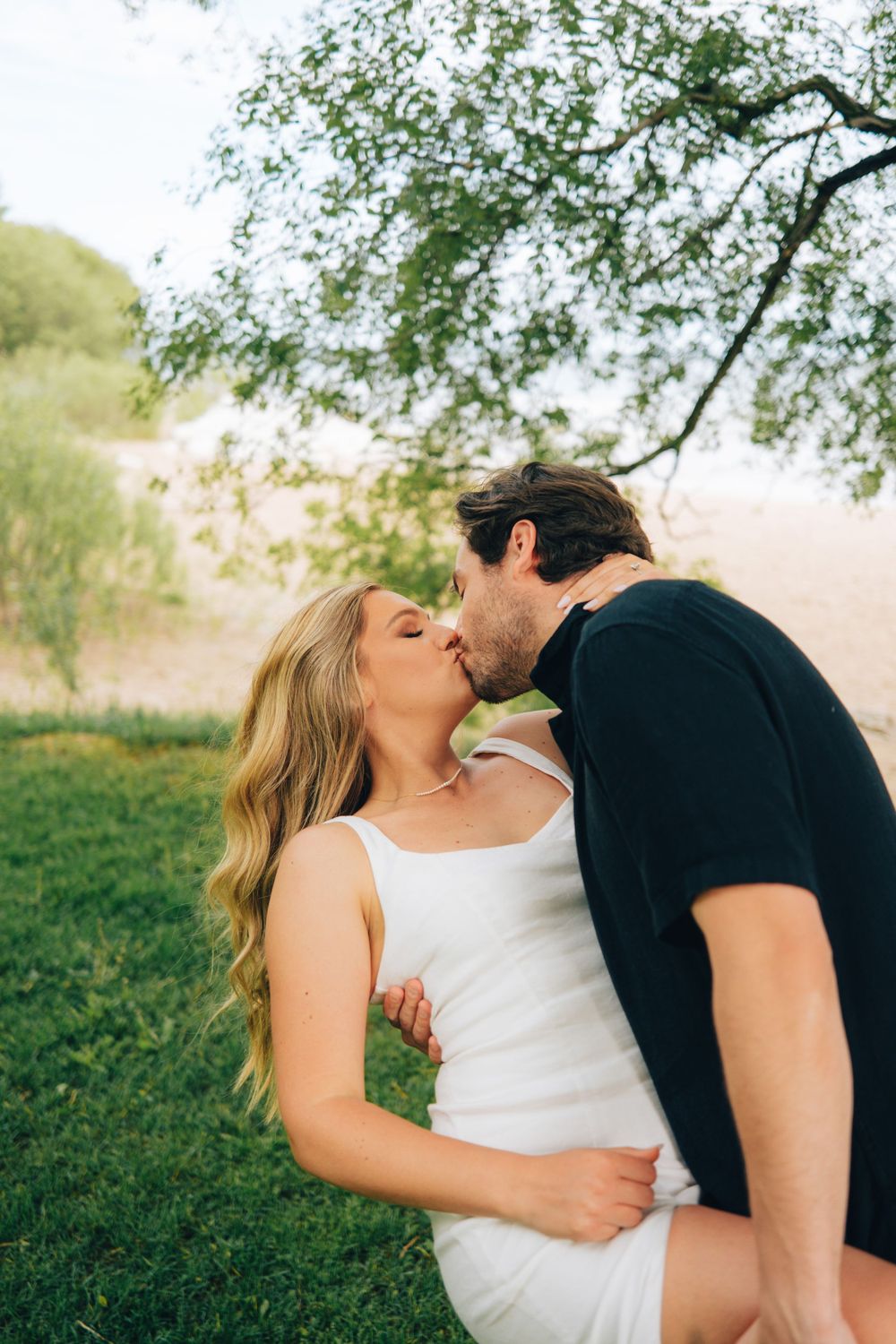 Intimate moment shared between couple in outdoor setting.