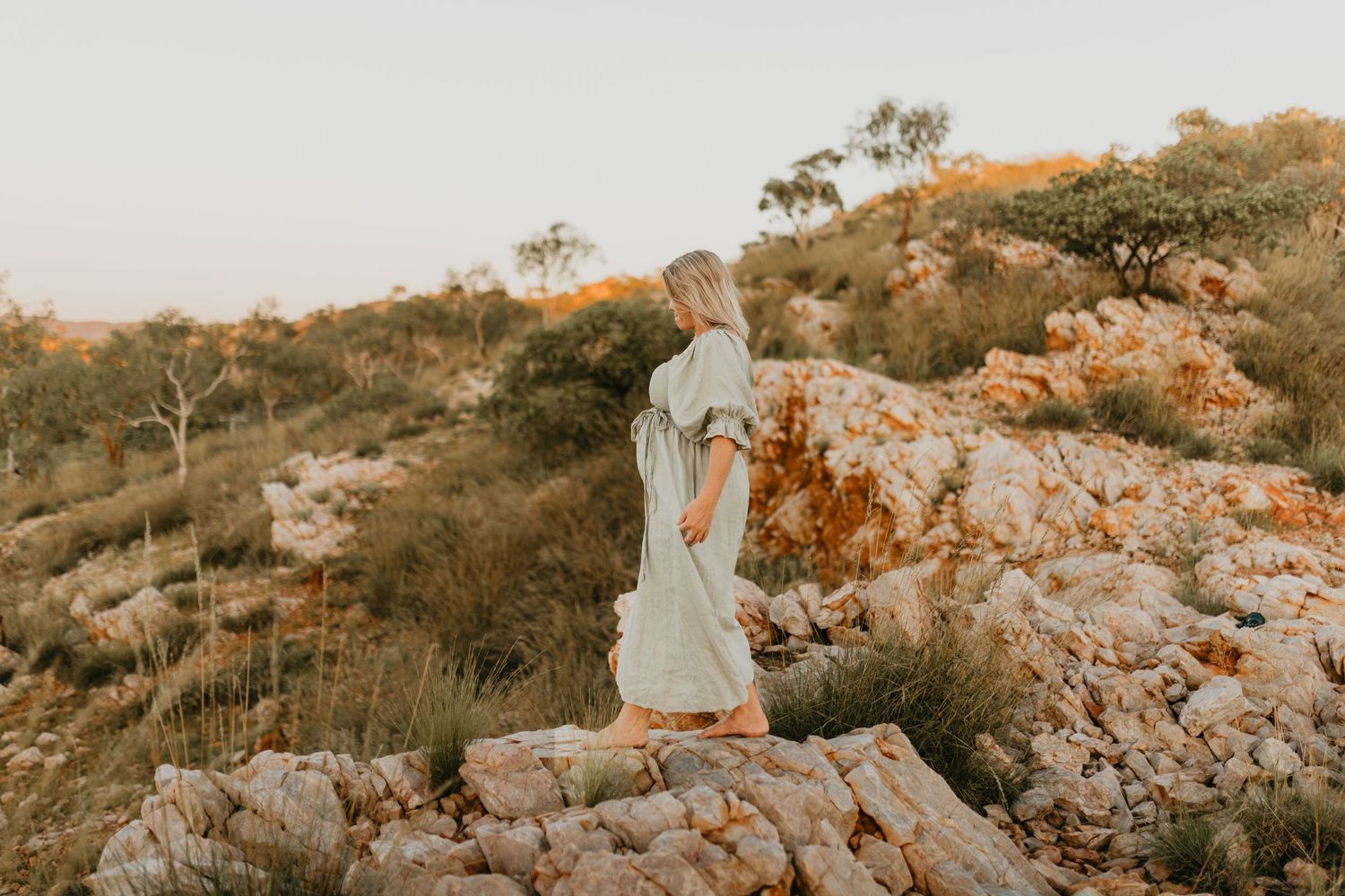 Woman walking along cliffs at Lake Moondarra, Mount Isa