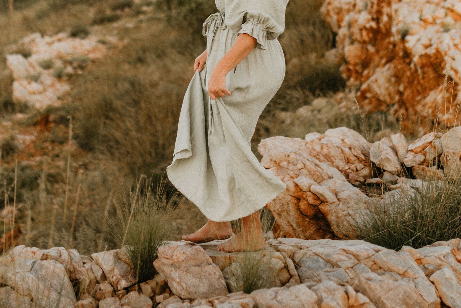 Detailed shot of womans feet on rocky cliffs at Lake Moondarra, Mount Isa