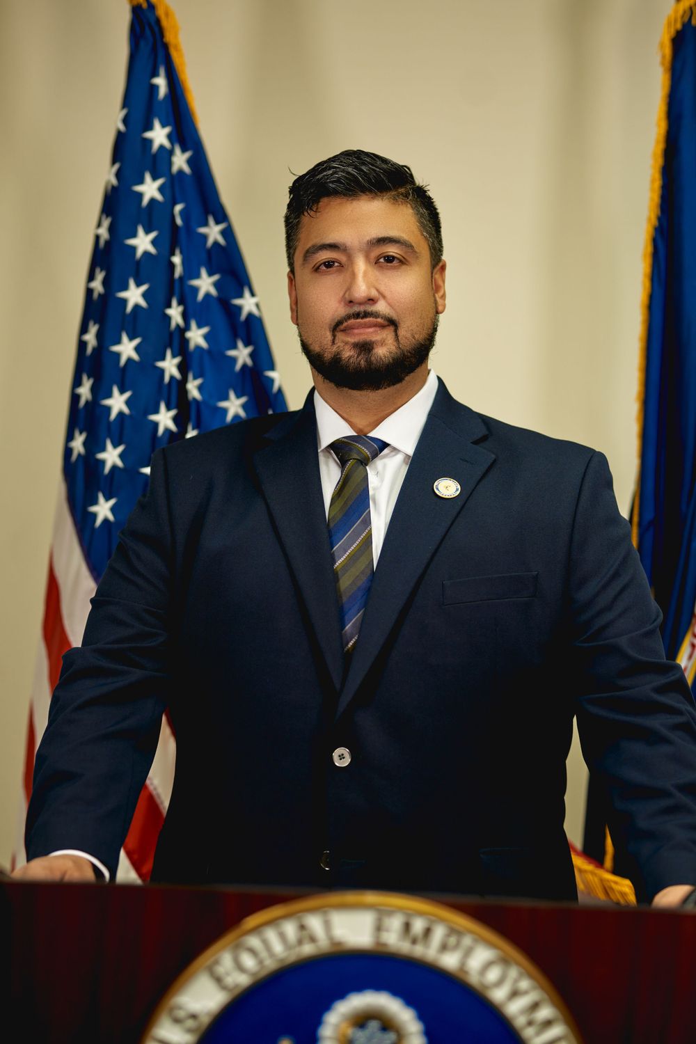 Official governmental portrait with American flag backdrop and podium.