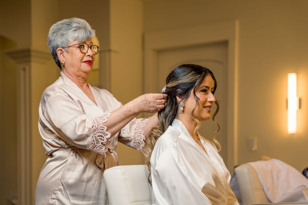 Wedding guests seated in rows during an indoor ceremony with warm lighting.