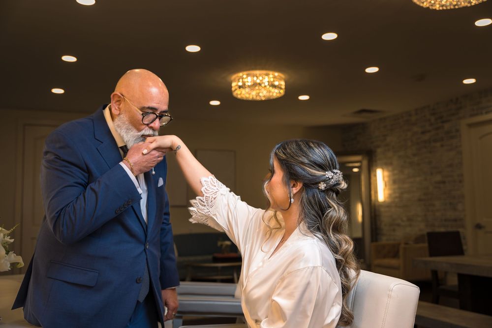 Wedding guests mingling and interacting during an indoor reception event.