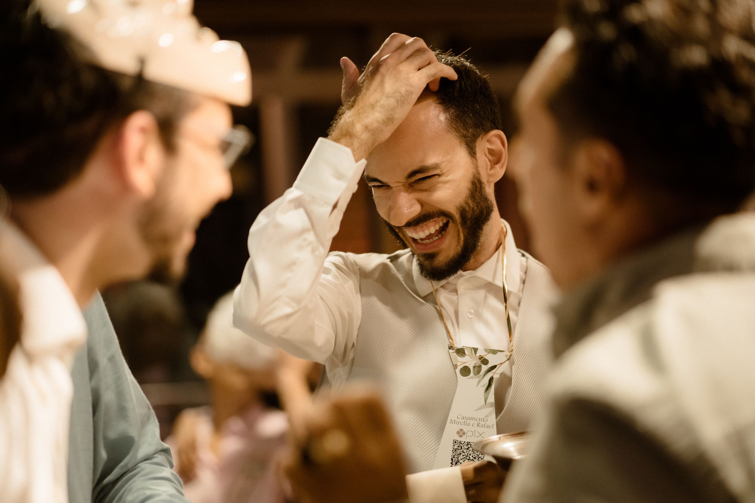 Guests share laughs during an intimate reception moment.