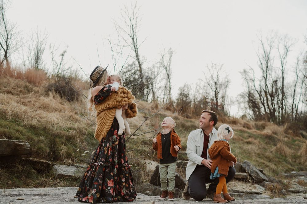 Playful outdoor gathering with casual interactions among people in autumn clothing.