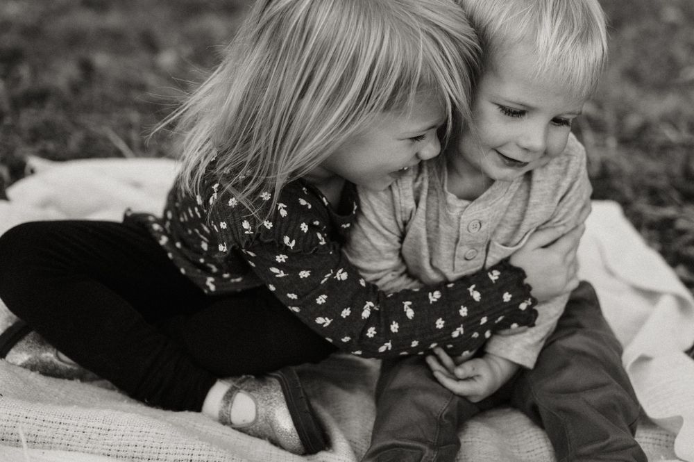 Intimate black and white portrait capturing tender moments of interaction.