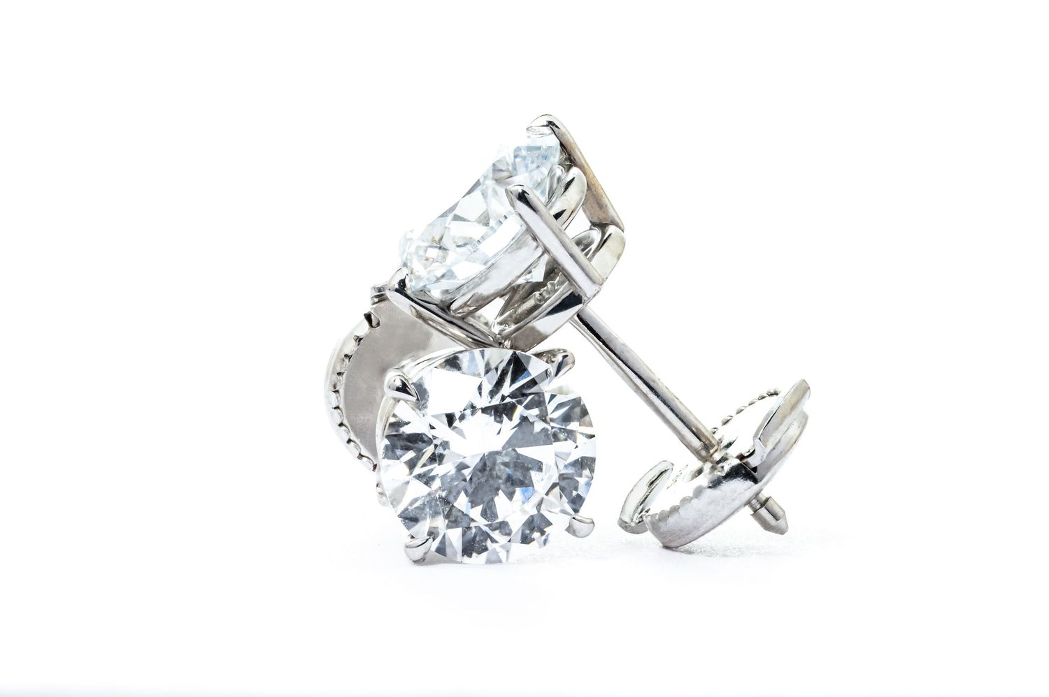 Sparkling round-cut diamond stud earrings with screw back posts set in white gold or platinum setting.