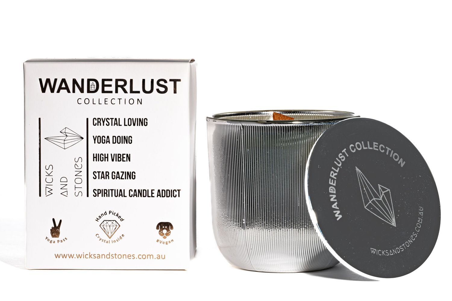 Minimalist silver and black Wanderlust Collection candle in ribbed metallic vessel with matching lid and product box.