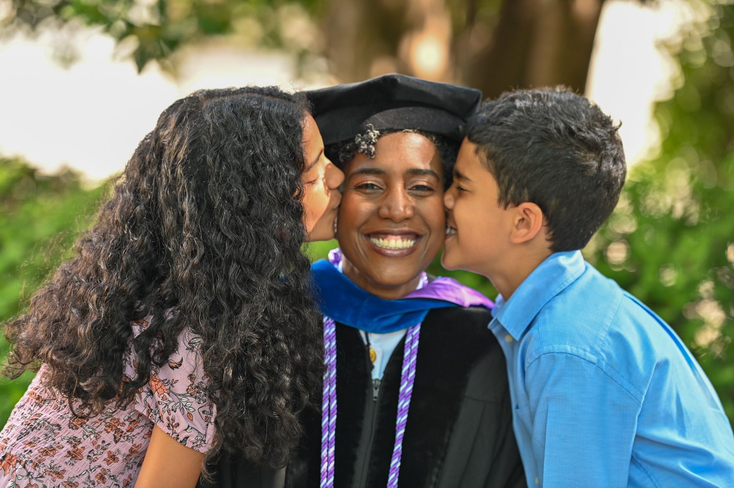 Children kissing their mother