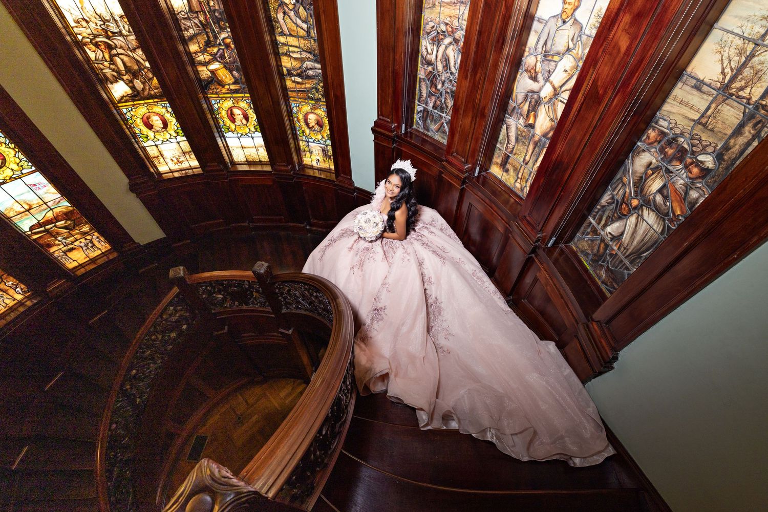 Ornate stained glass windows and wooden beams create dramatic wedding venue interior.