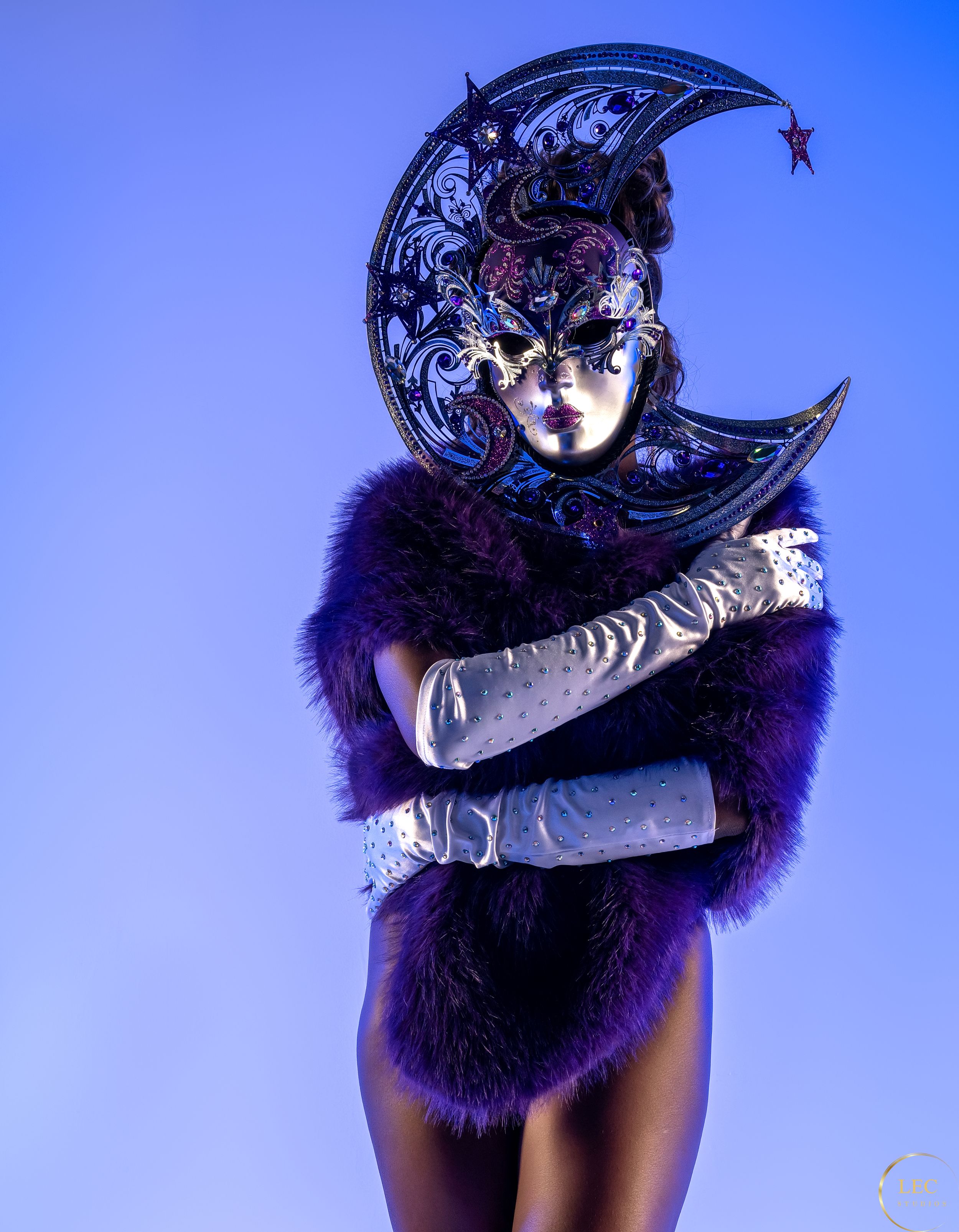 Image of lady with silver mask, white gloves, and purple cape