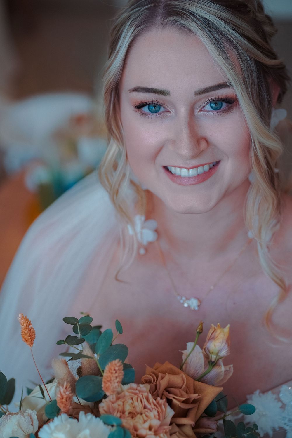 A series of close-up photos showing joyful expressions with peach and teal floral arrangements in soft focus.