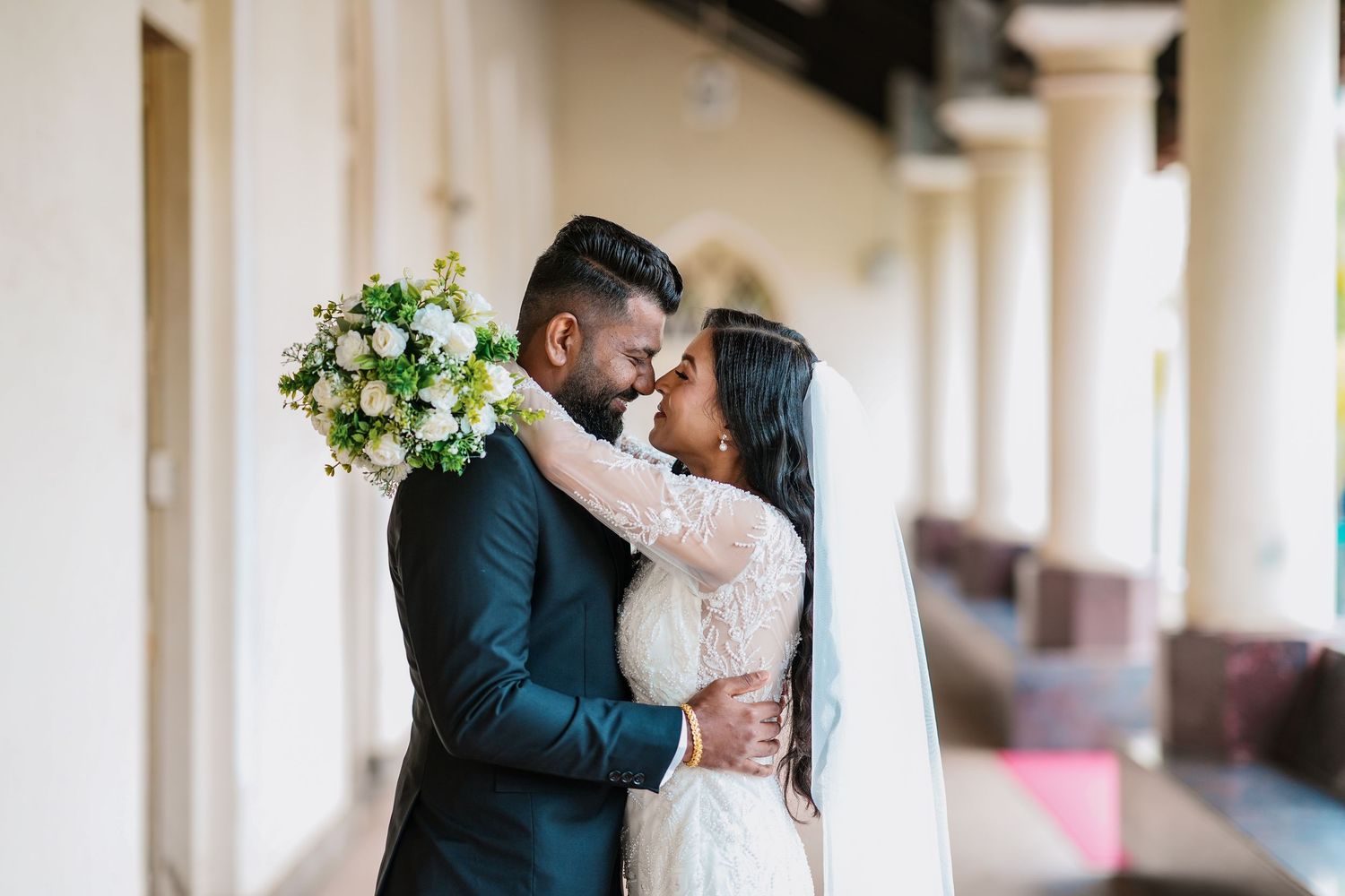 Bride and groom embracing in a wedding portrait at an elegant venue