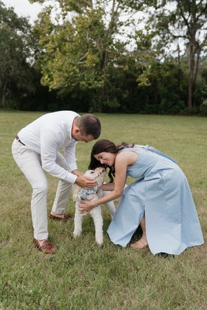 Two people in white and blue clothing crouch down together on grassy ground in a series of progressive shots.