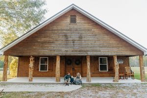 Rustic wooden cabin exterior with multiple views showing log construction and covered porch in natural setting.