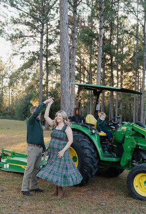 A series of playful photos showing a couple posing with a green John Deere tractor in a pine forest setting.