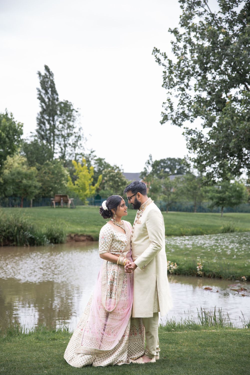 intimate newly weds holding each other and smiling  showing their love towards the camera