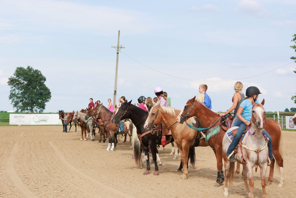 Horse show competitors lined up on horseback for the National Anthem.