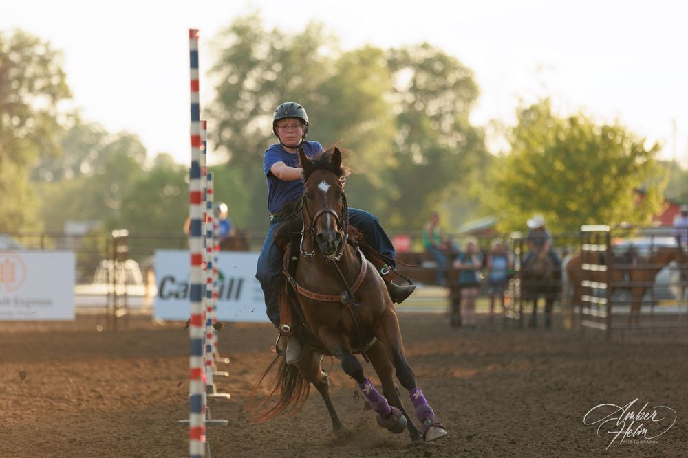 Young boy riding his horse during a polebending competition.