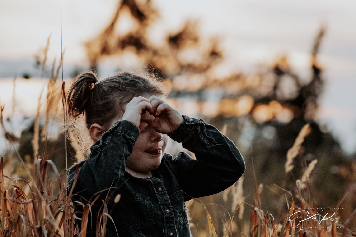 Adorable child smiling during an outdoor photography session in Northern BC, by Captured Moments Photography.