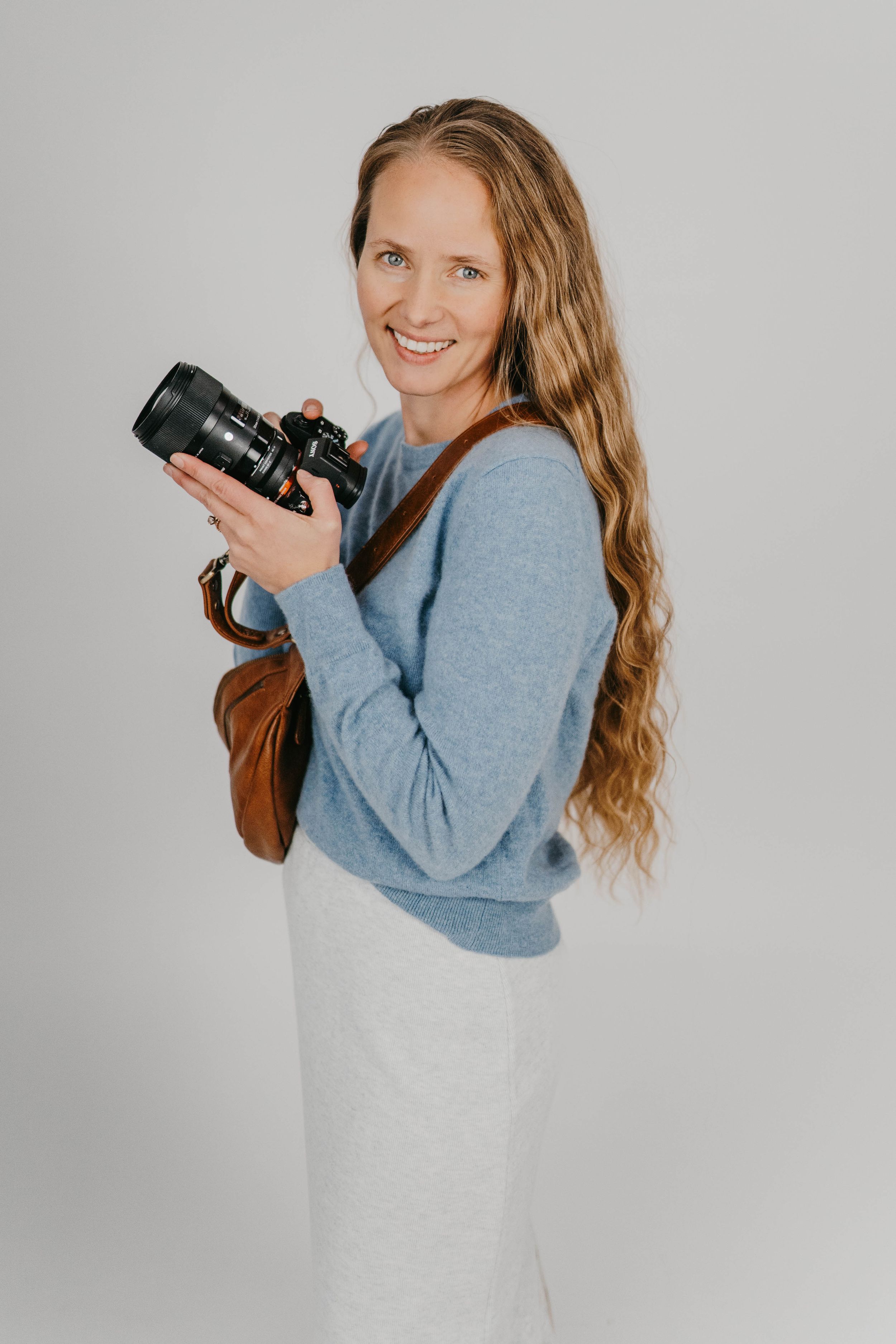 Professional headshots of a woman in a beige blazer and black top against a light background.