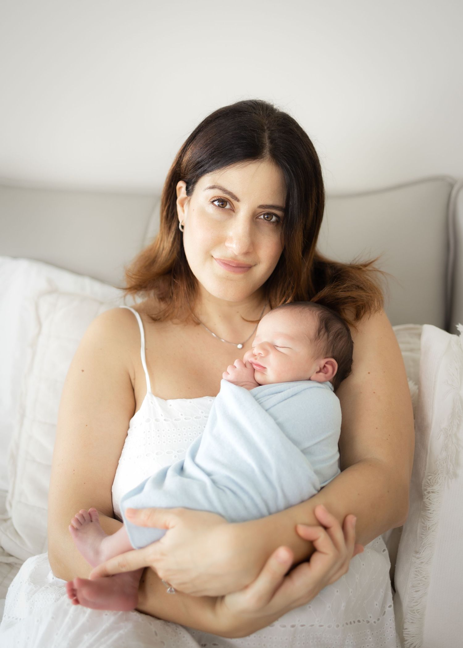 A tender moment captured in a series of photos showing a parent cradling and bonding with their newborn baby.