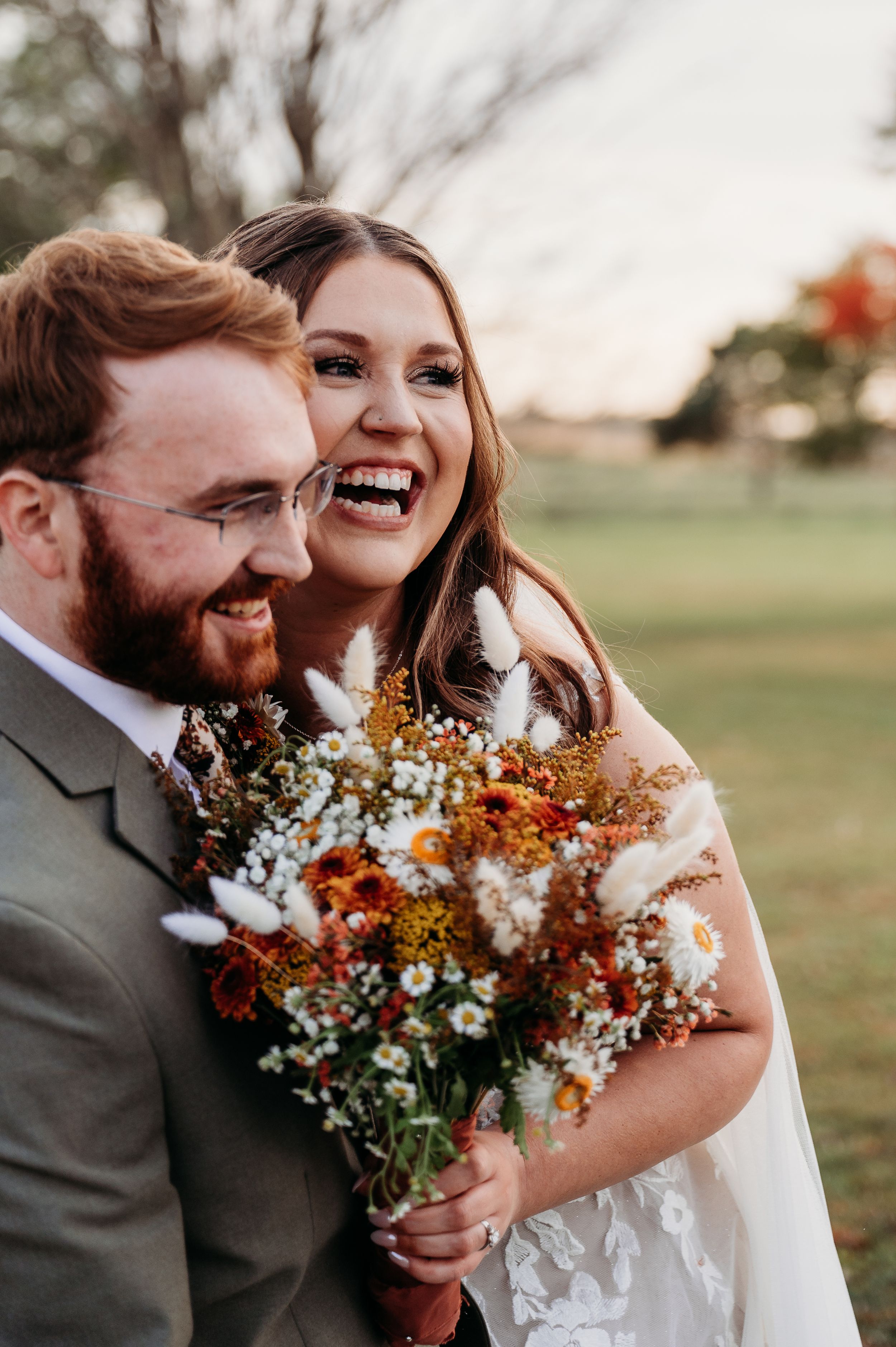 Fall wedding at Barn at Brophy Creek Iowa. Bride and groom after ceremony. Smiling big with fall vibes by midwest Iowa photographer