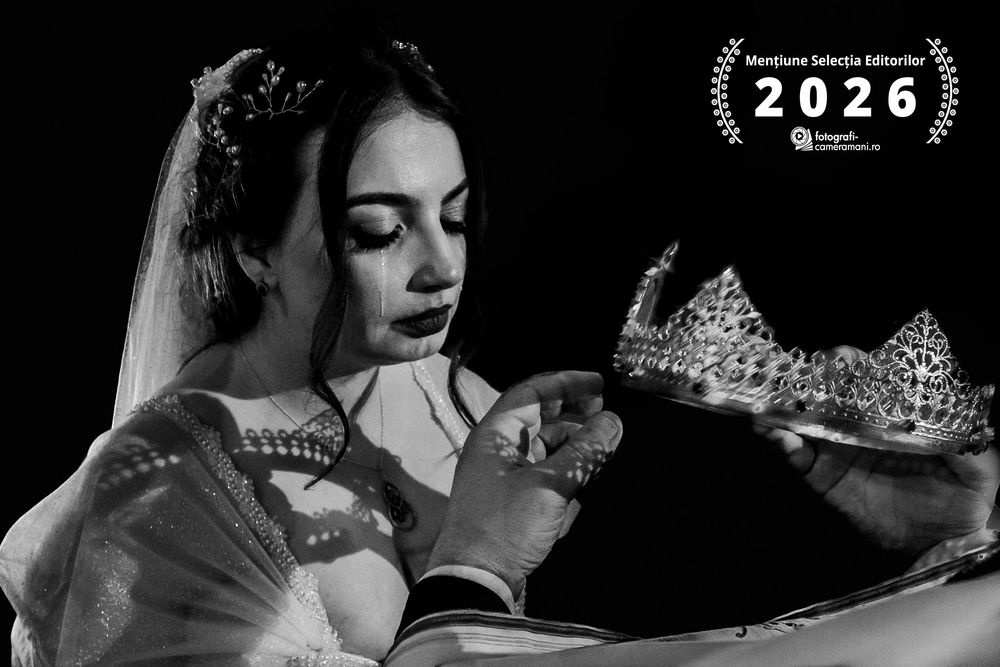 Black and white photo of a bride in veil examining a sparkling tiara crown, award winning 2026 editorial selection.