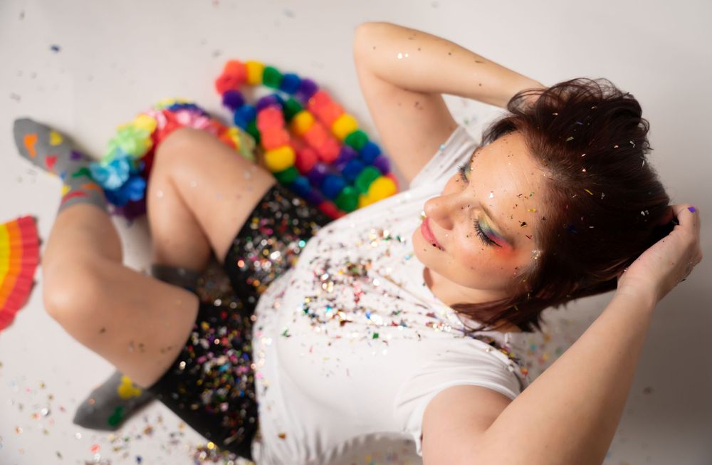 Horizontal series of artistic poses with rainbow elements and scattered confetti.