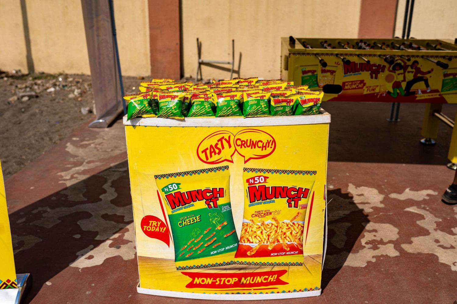 Box of Indomie noodles displayed with green packages on top.
