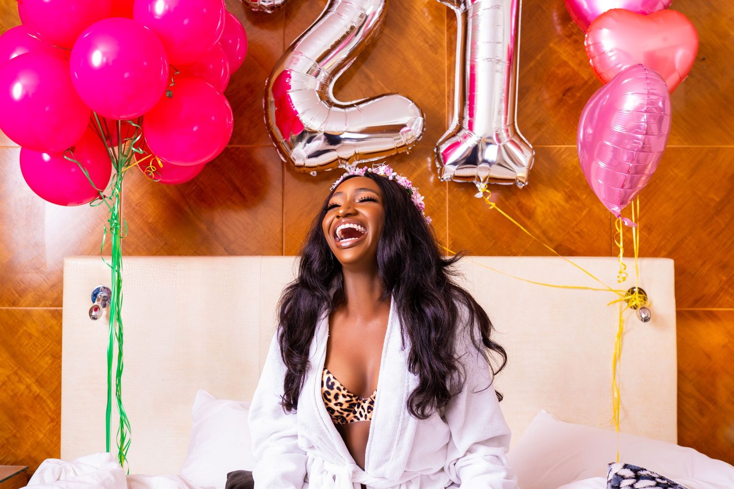 Celebratory photo with silver number balloons and pink decorations.