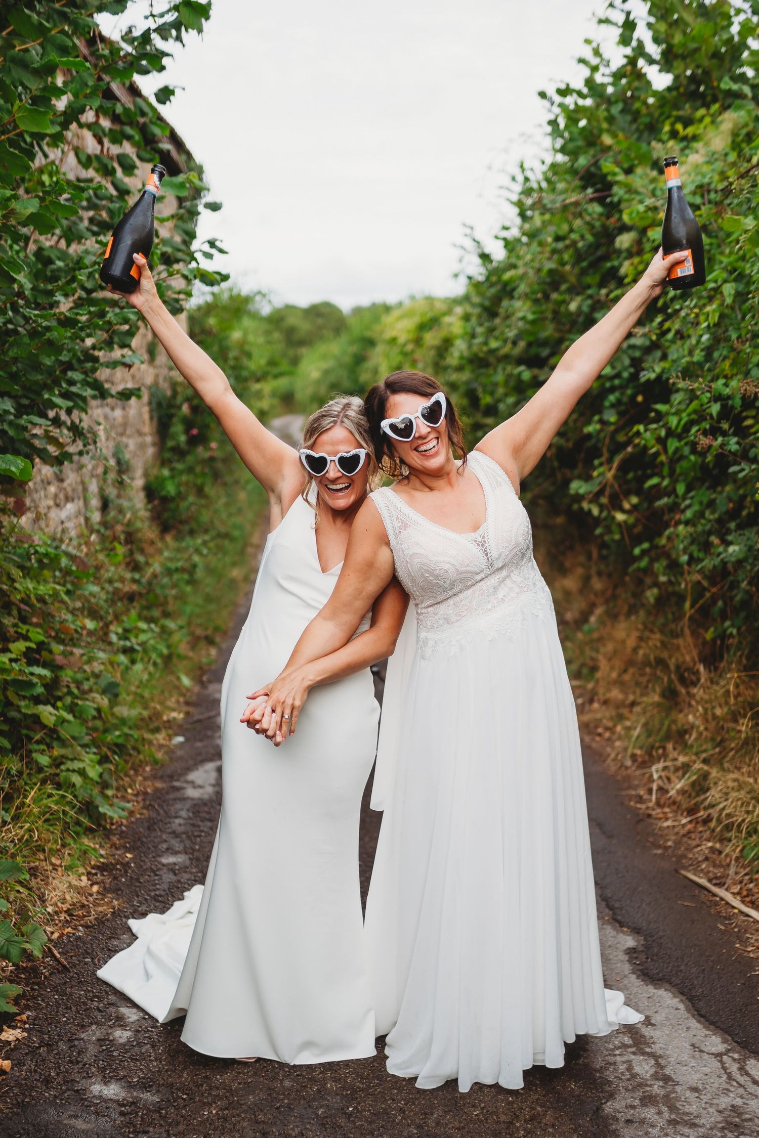 Two brides share a sweet intimate moment during speeches at Mouton Brook Lodge