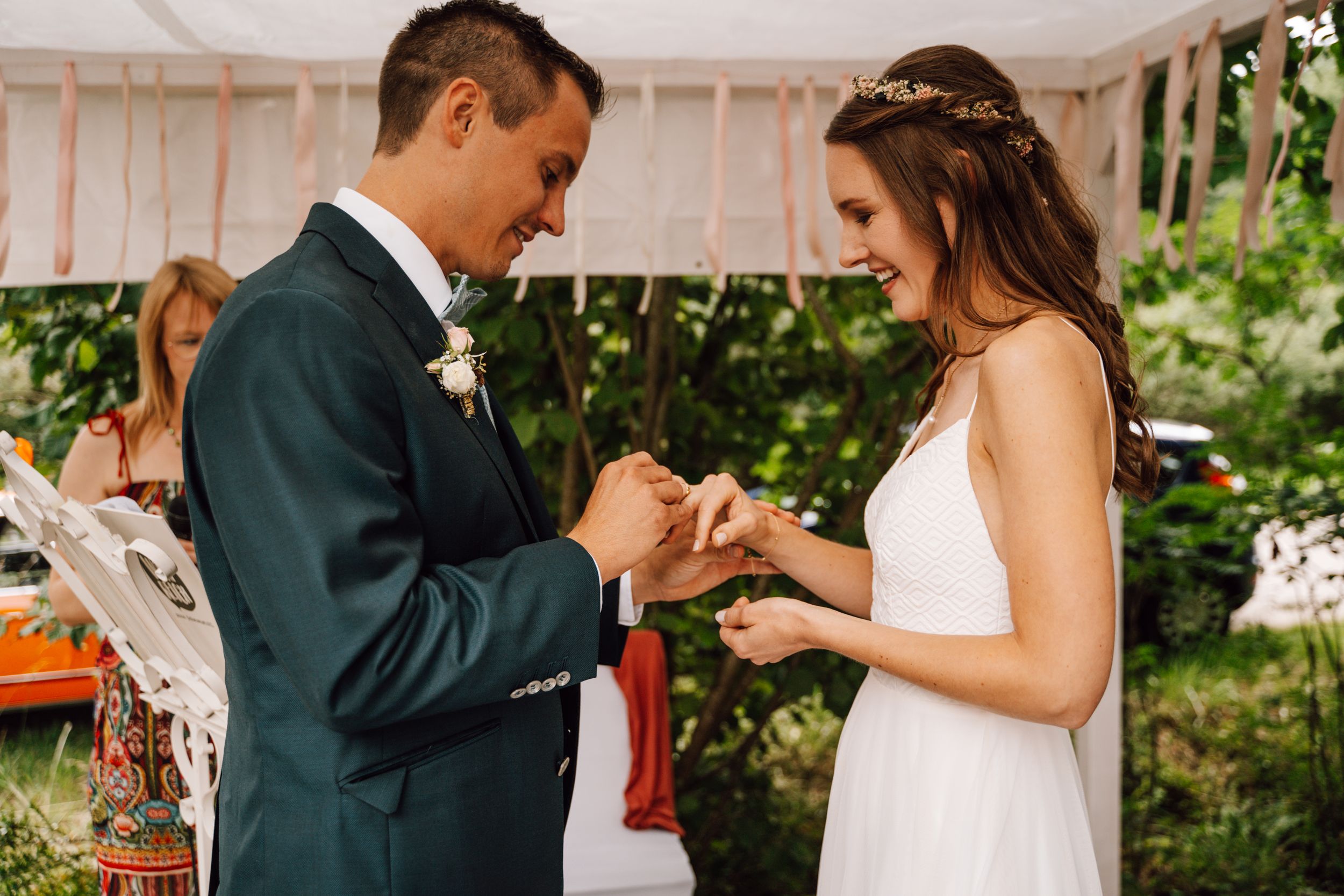 First dance celebration under white tent with romantic lighting.