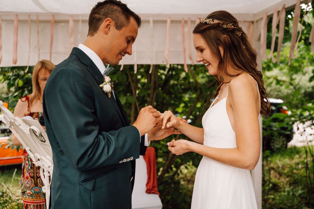 First dance celebration under white tent with romantic lighting.