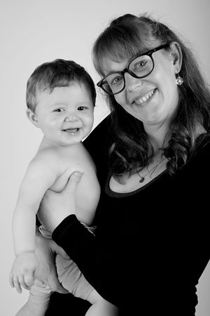 Playful black and white portrait of parent and laughing toddler.